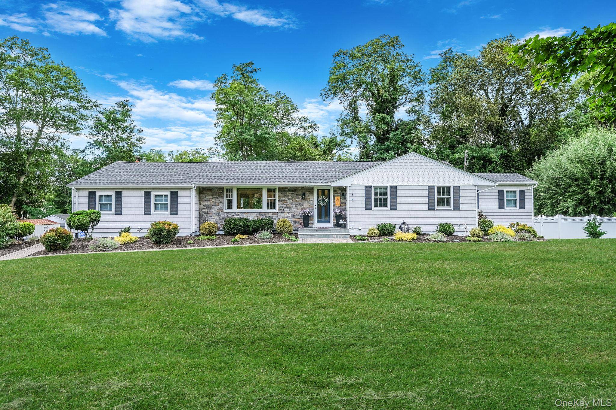 Welcome to this beautifully expanded ranch in the heart of Wading River, where modern updates meet timeless elegance.