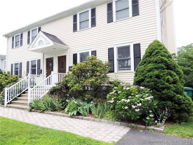 Spacious and well maintained half duplex with attractive mature plantings.