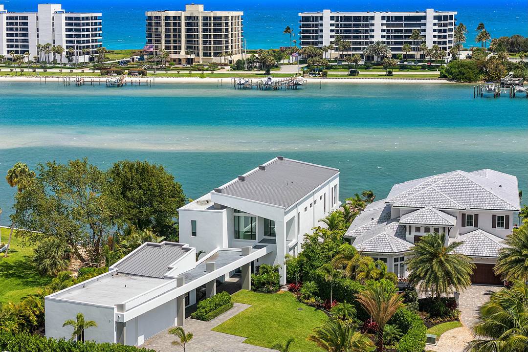 This breathtaking modern estate, built in 2022 by Rothrock Construction, boasts 180 feet of Intracoastal frontage with stunning blue water views.