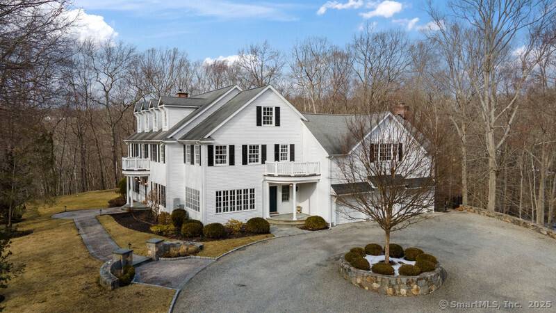 Nestled in a serene and private setting, this stunning custom colonial offers the perfect blend of elegance and comfort.