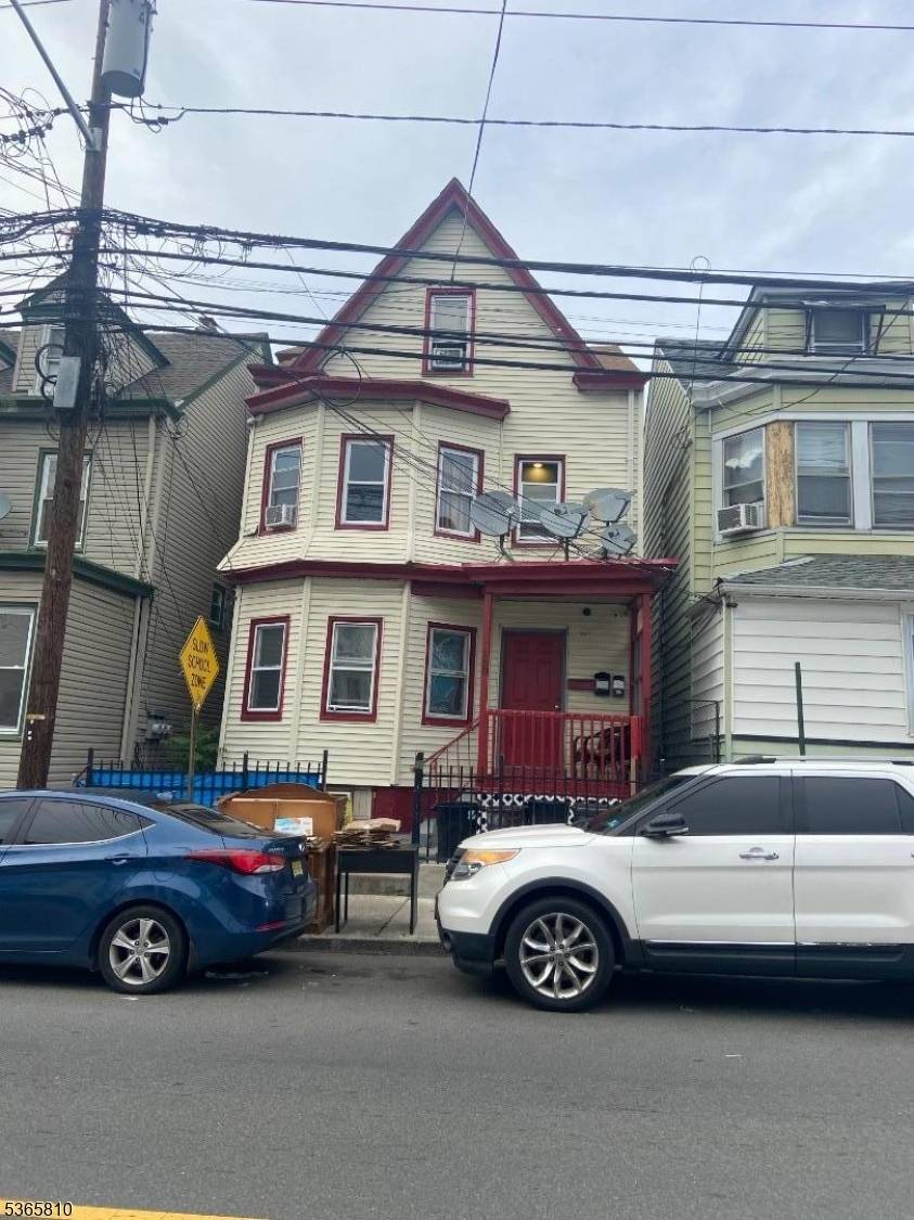 Property fully rented, offers 3 bedrooms each floor with finished attic, separate utilities.
