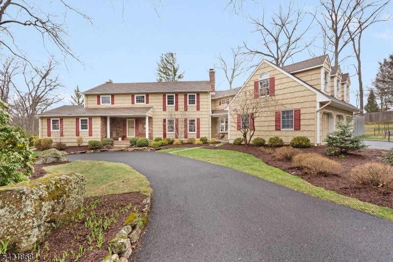 Flawless expanded Center Hall Colonial set back beautifully on a 1.