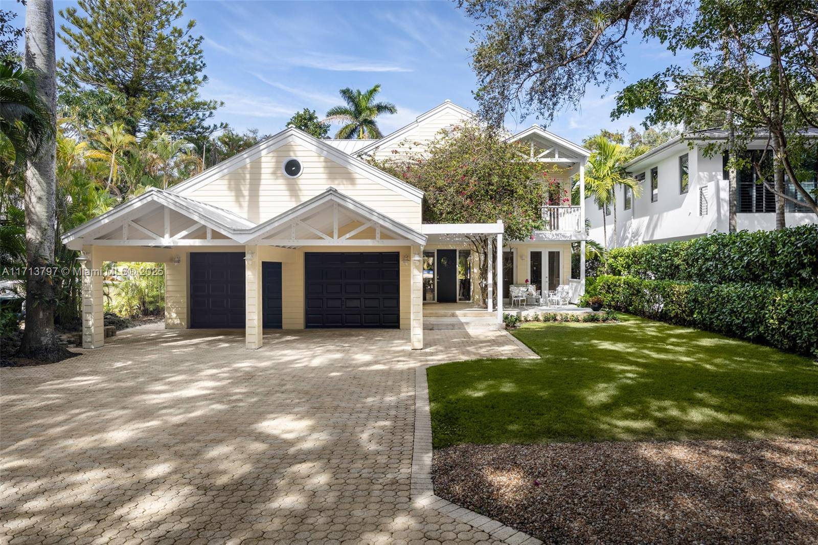 Captivating Key West style home on a coveted tree canopied street in prestigious North Coconut Grove.