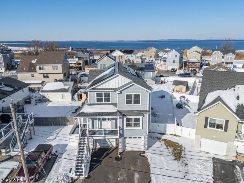 Just moments from the sand, this beautifully crafted four year young custom home offers the rare opportunity to enjoy beachside living without compromise.