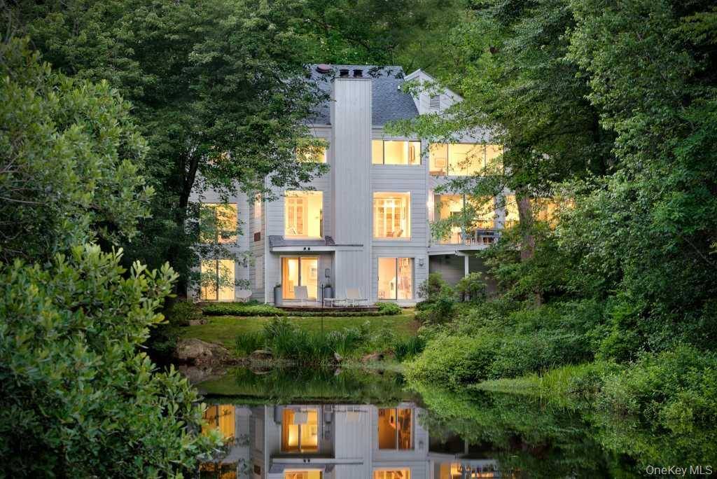 Tucked beside a peaceful pond in Pound Ridge, this contemporary retreat feels like living inside a work of art.