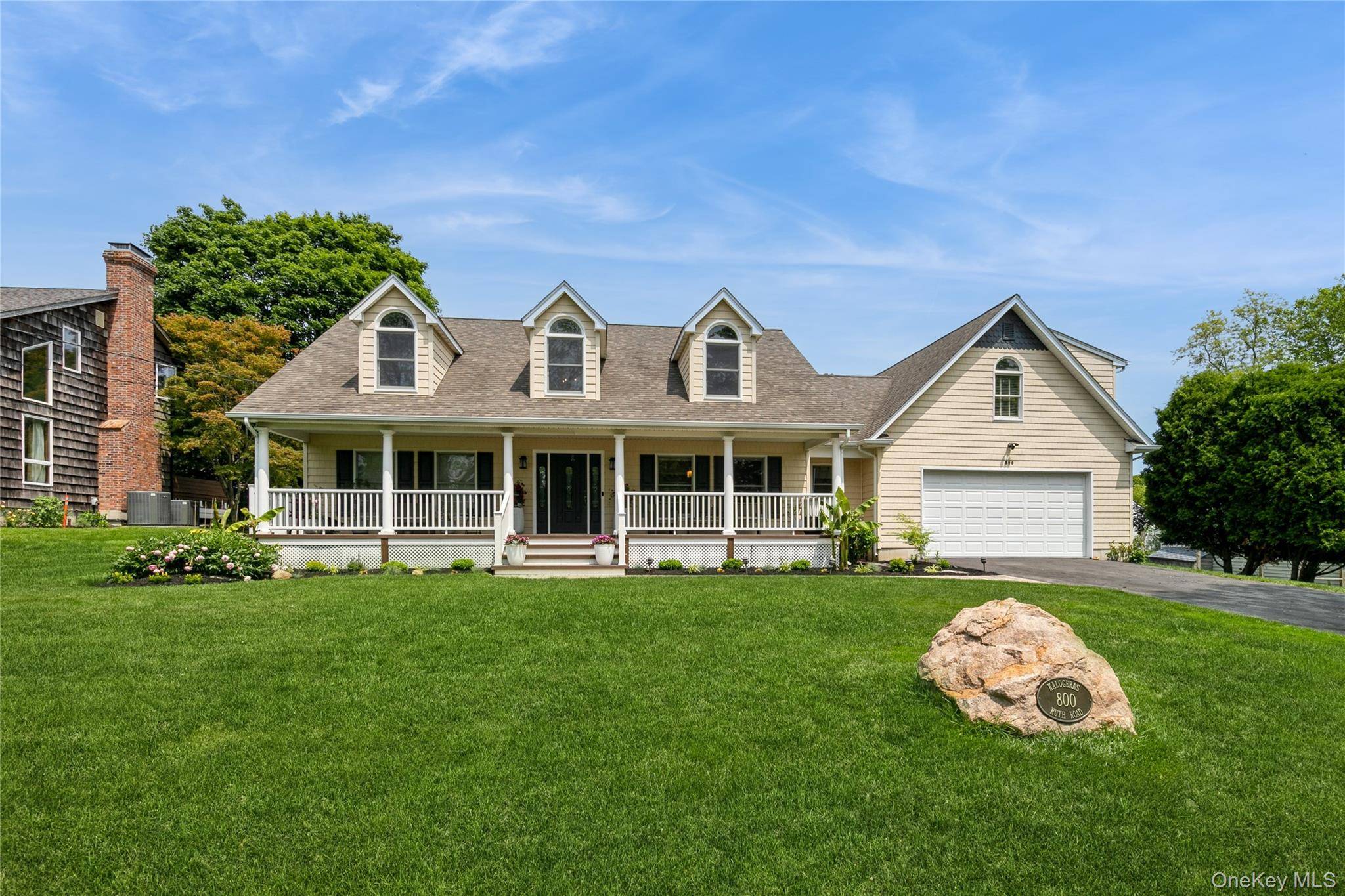 Mattituck, Captain Kidd Estates SEASONAL RENTAL by Breakwater Beach classic Cape Cod style home features a broad covered entry porch to idle away the hours.