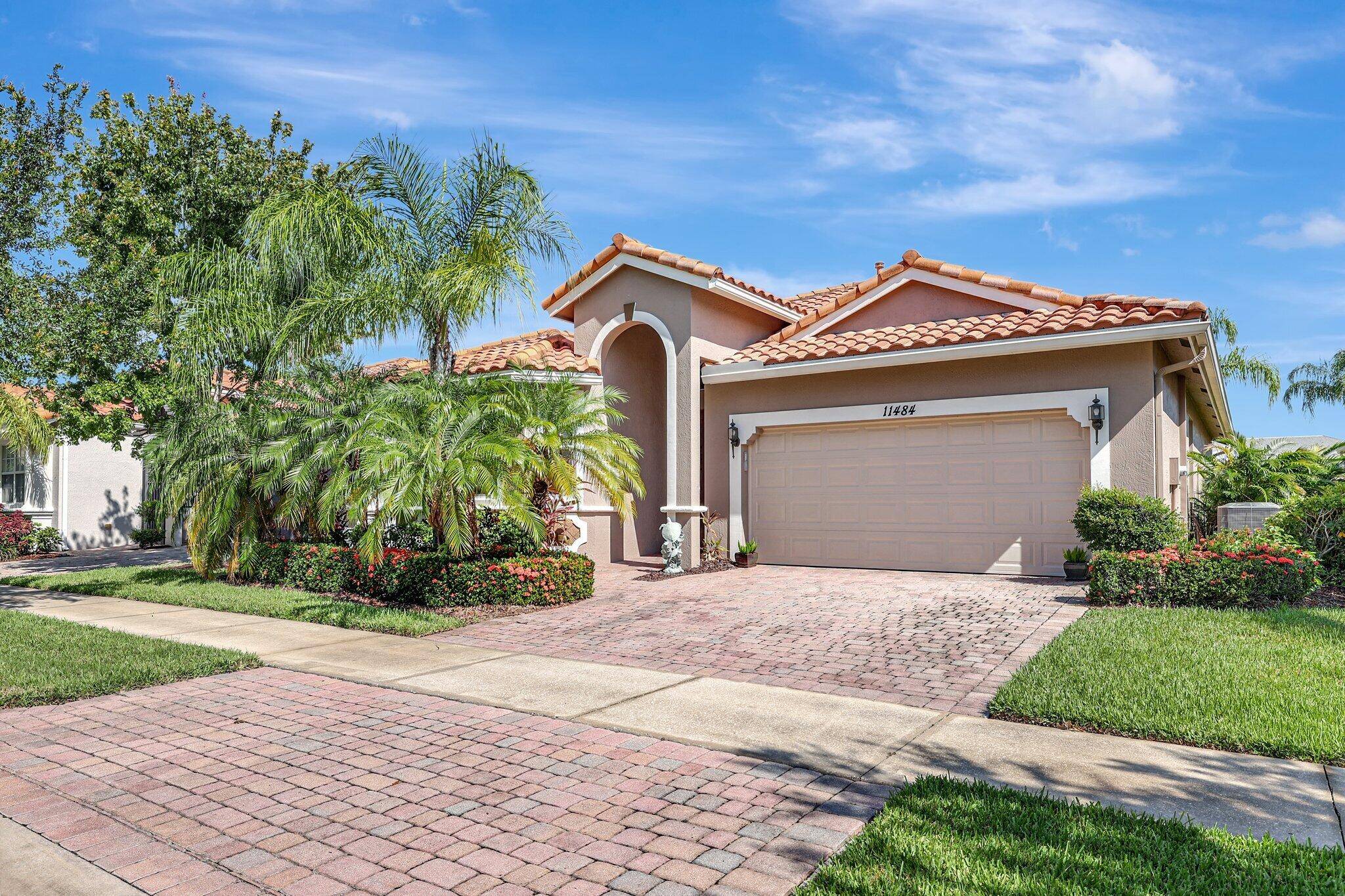 The spacious open plan living area is bathed in natural light, highlighting the cathedral ceilings and elegant crown molding for a sophisticated feel.
