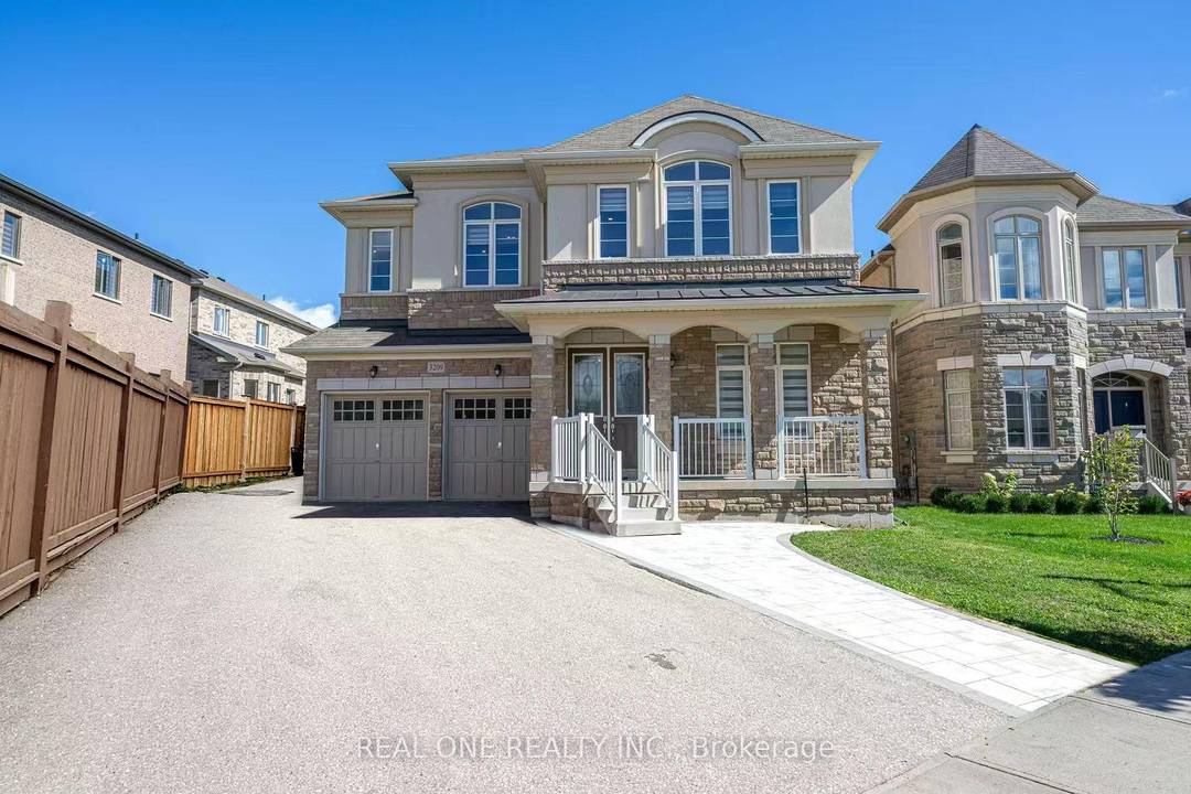 Stunning luxury home with elegant stone exterior and a spacious front porch.