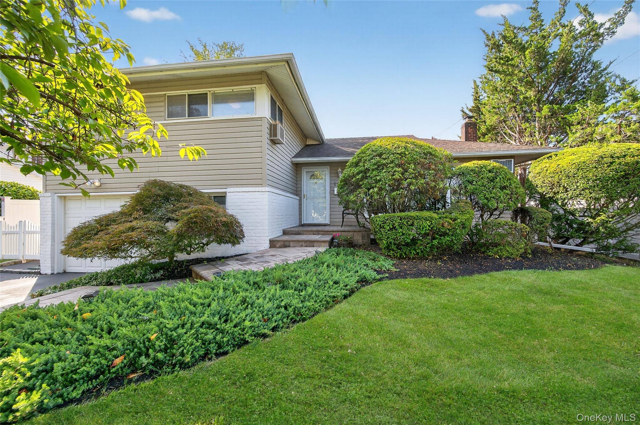 This lovely, updated, sun flooded split level home is set in a quiet neighborhood location.