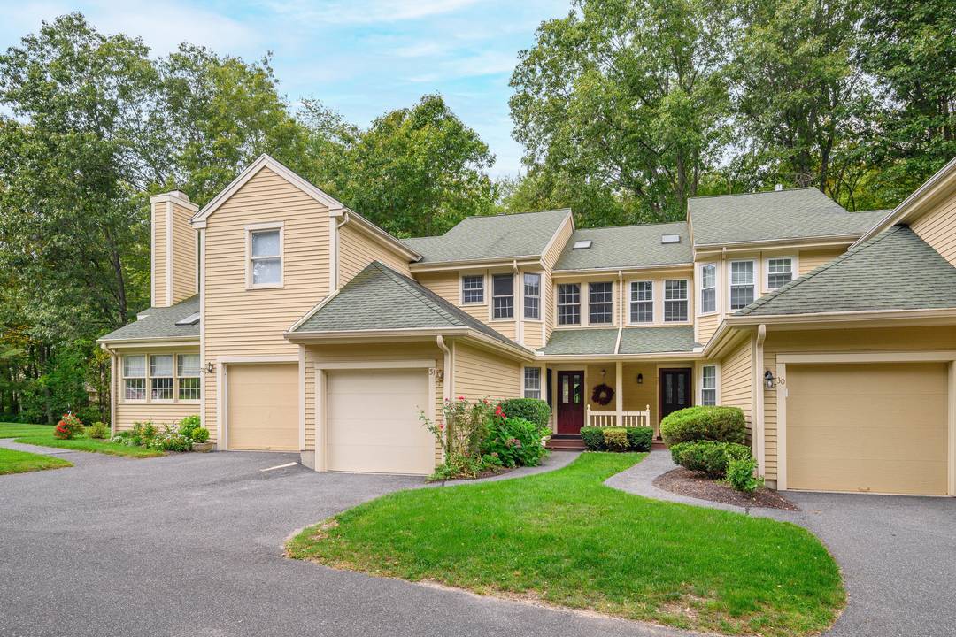 Sought after Sullivan Farm townhome nestled in the woods on a quiet cul de sac with rights to Candlewood Lake.