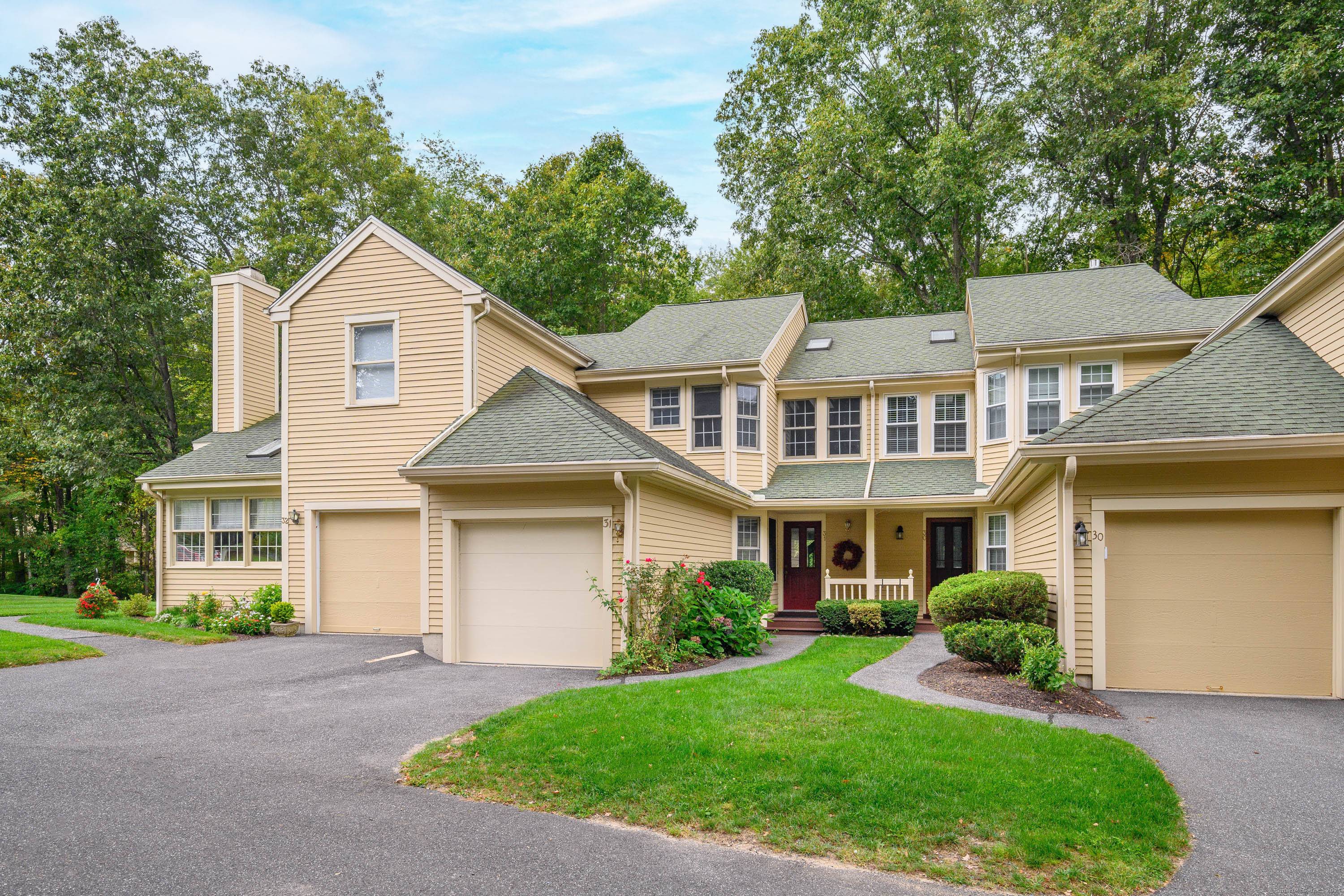 Sought after Sullivan Farm townhome nestled in the woods on a quiet cul de sac with rights to Candlewood Lake.