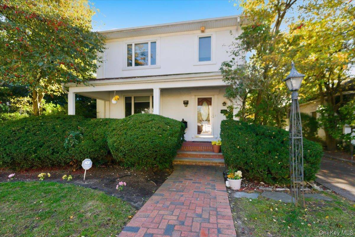 Welcome to 1053 Quentin Pl, a charming colonial on a quiet, picturesque block in the heart of Woodmere.