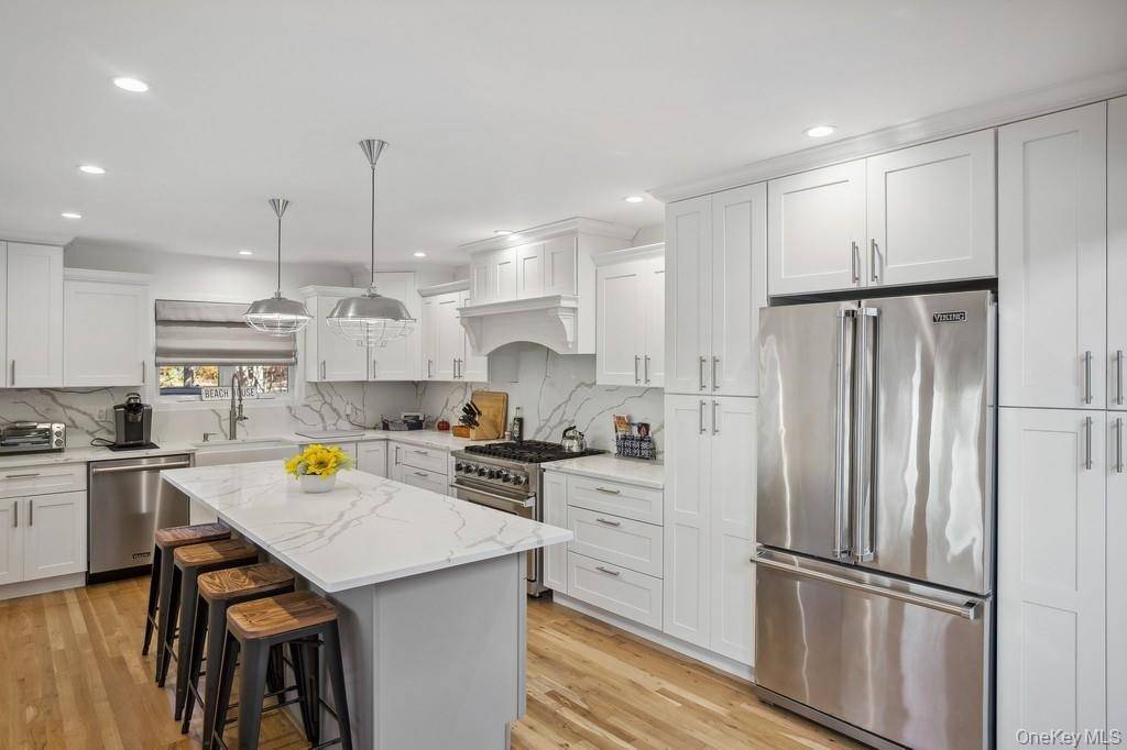 Nestled in the heart of prestigious Quogue Village, this stunning 4 bedroom, 2.