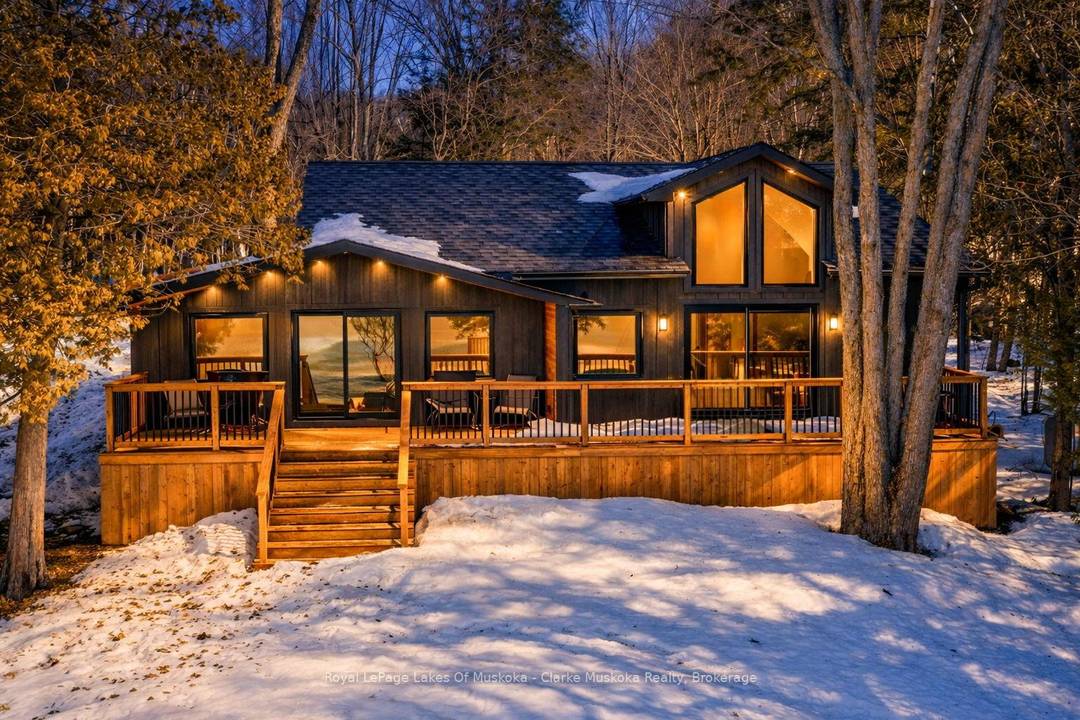 Experience the pinnacle of turnkey lakeside living in a sheltered bay on the crystal clear waters of Skeleton Lake.