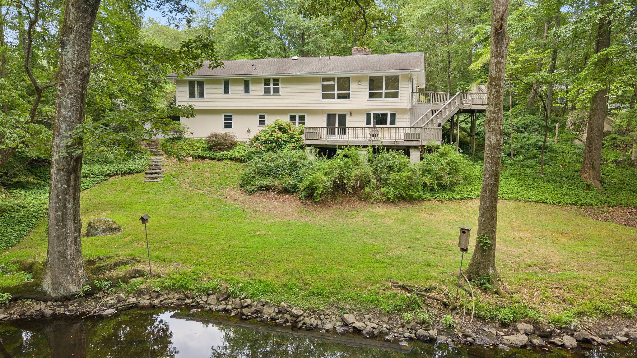 Enjoy a serene country retreat in this airy, light filled Ranch nestled in the sought after Saw Mill Association.