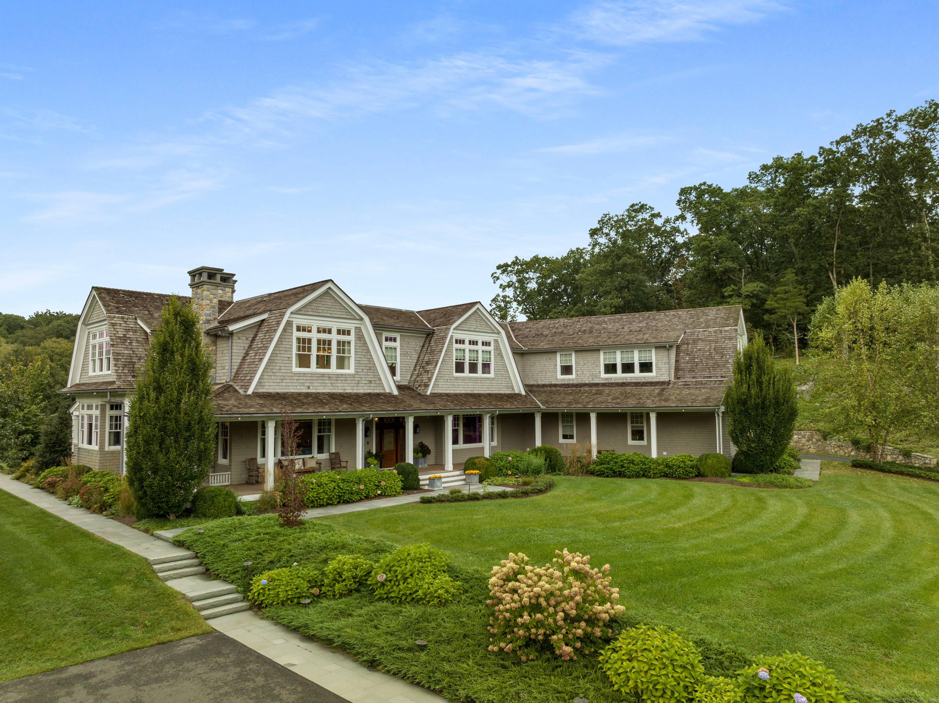 A rare offering, this Gambrel shingle style estate is a sanctuary on over 6 acres on a cul de sac, offering a secluded retreat.