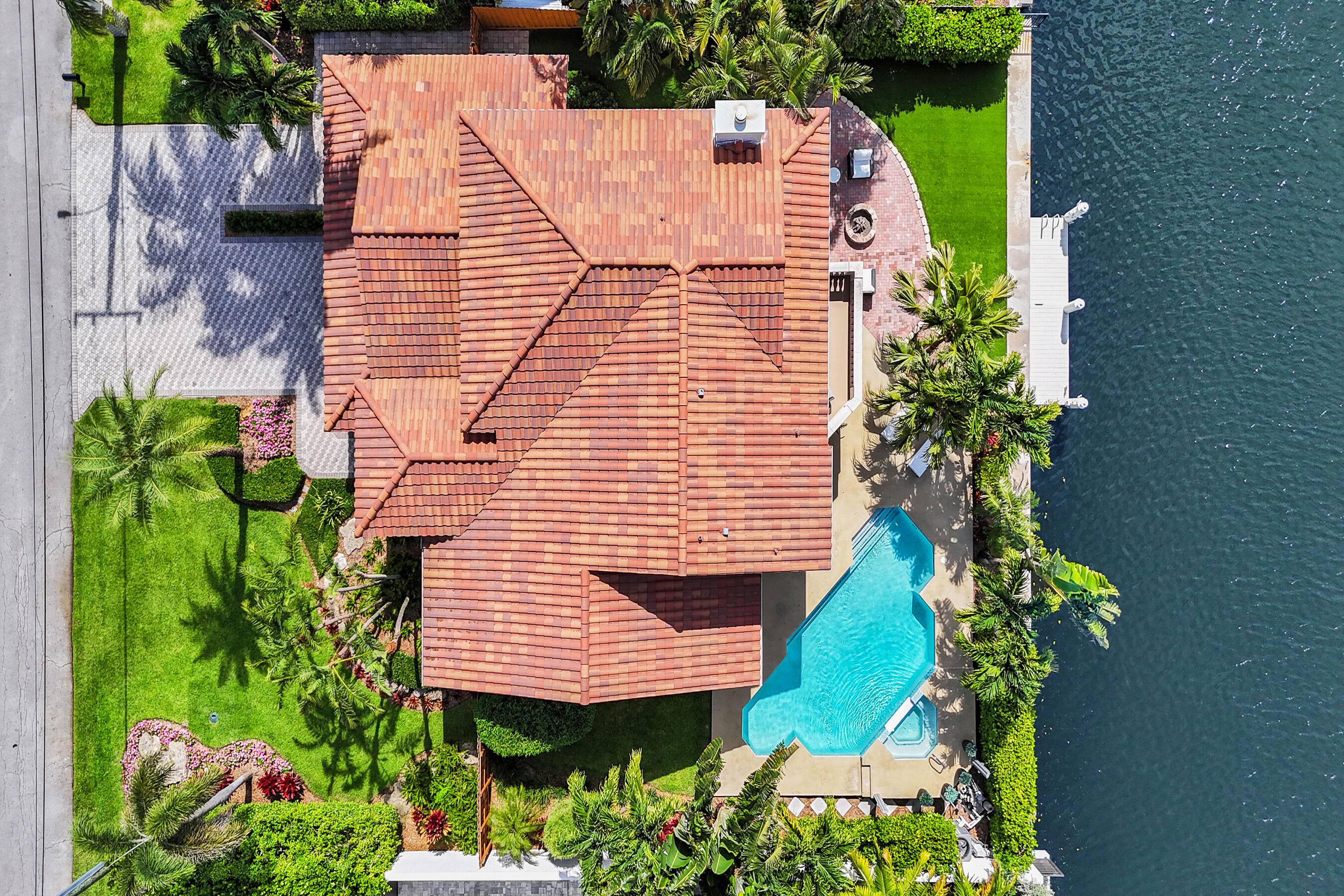 Discover your slice of paradise in this exquisite 4 bedroom, 3 bathroom, 3 car garage home, perfectly situated on 90' of prime waterfront in the highly sought after Tropic Isles ...