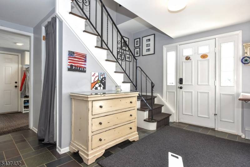 Set back from hurry and the noise of passing days, this four bedroom raised ranch stands where the street grows still.