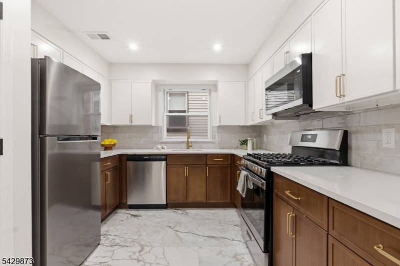 Exceptional two family home spread across 3 spacious levels, offering a rare opportunity for both investors and owner occupants.