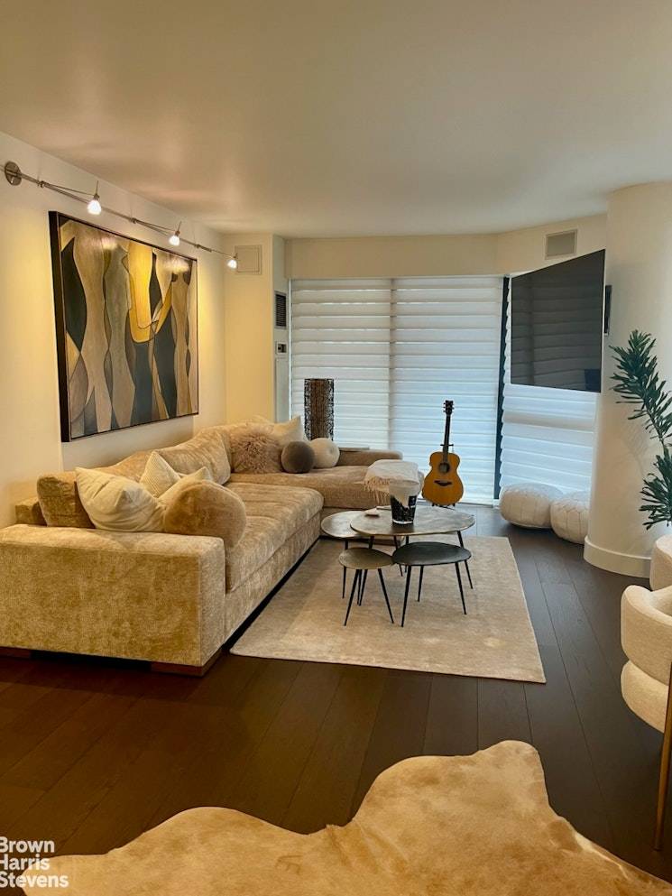 Triple Mint large one bedroom featuring a chef's kitchen with Bertazoni oven with overhead exhaust, Fisher amp ; Paykel refrigerator and Whirlpool dishwasher, beautiful natural wood cabinetry, gorgeous hardwood plank ...