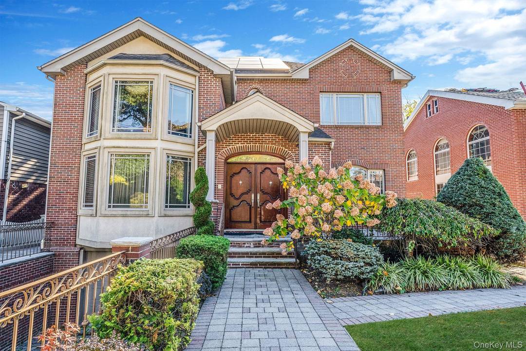 Built in 2002, this exceptional brick residence blends grand architectural design with modern comfort throughout.