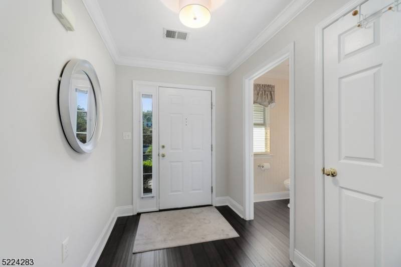 This luxury townhome features an open floor plan, dramatic 2 story living room with gas fireplace, wall of windows, and rich hardwood floors.