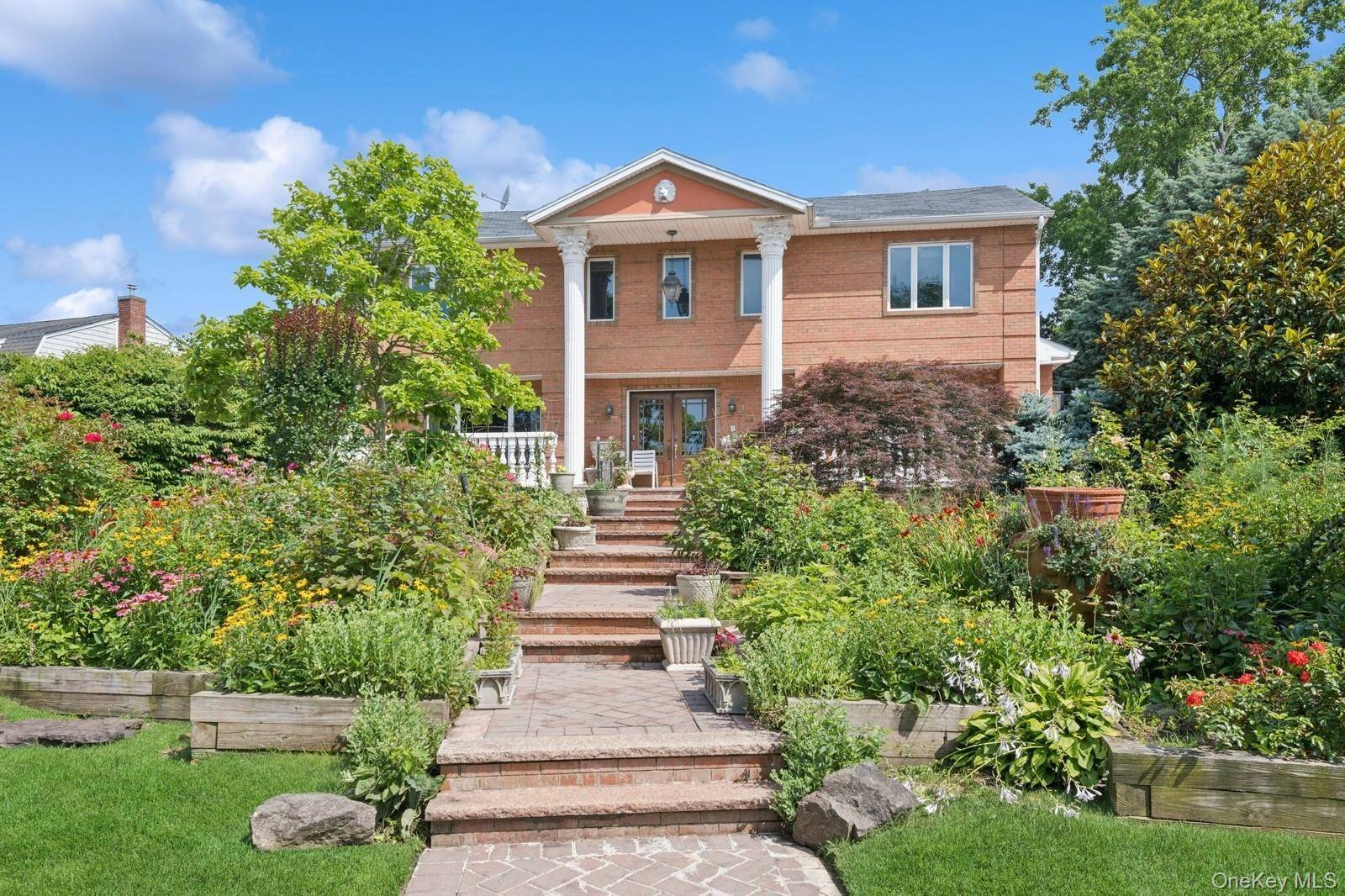 Stately 7 Bedroom, 7 Bath Brick Estate with Water Views in Prime Woodsburgh Location.