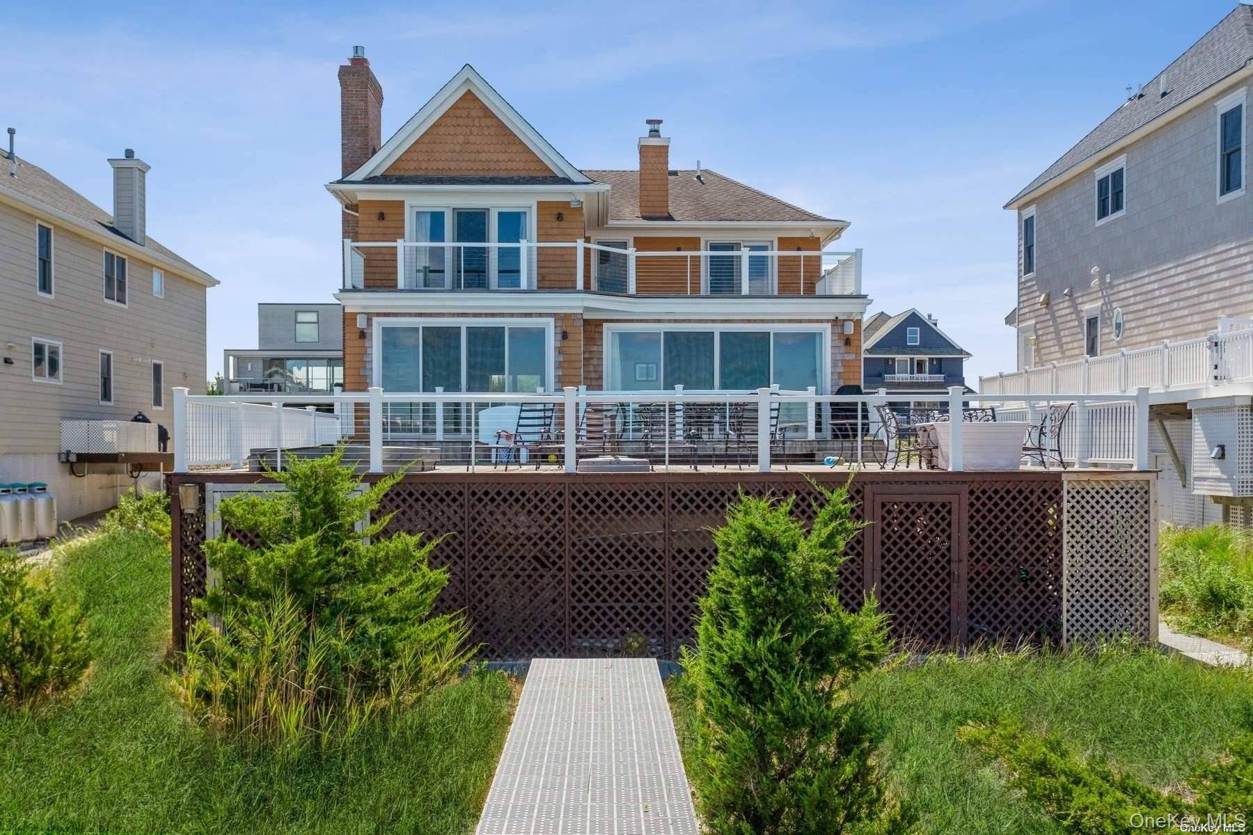 BEAUTIFUL BAYFRONT 5 BDRM BEACH HOUSE Enjoy your summer vacation at the beach with your feet in the sand and the sun on your face at this beautifully crafted 5 ...