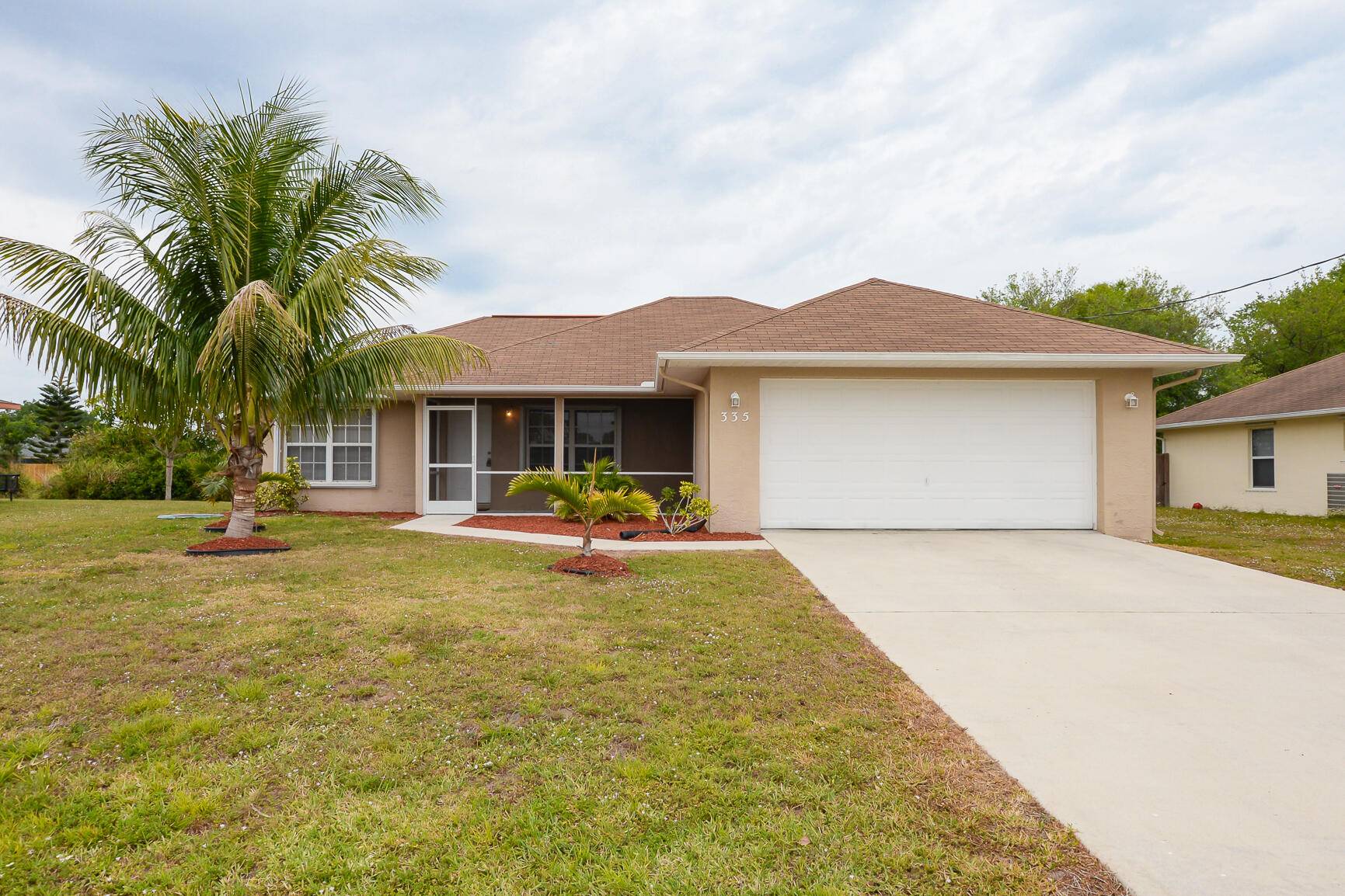Fabulous Home in Port St Lucie features CBS Construction, concrete driveway, 3 Bedrooms, 2 Baths 2 Car Garage.