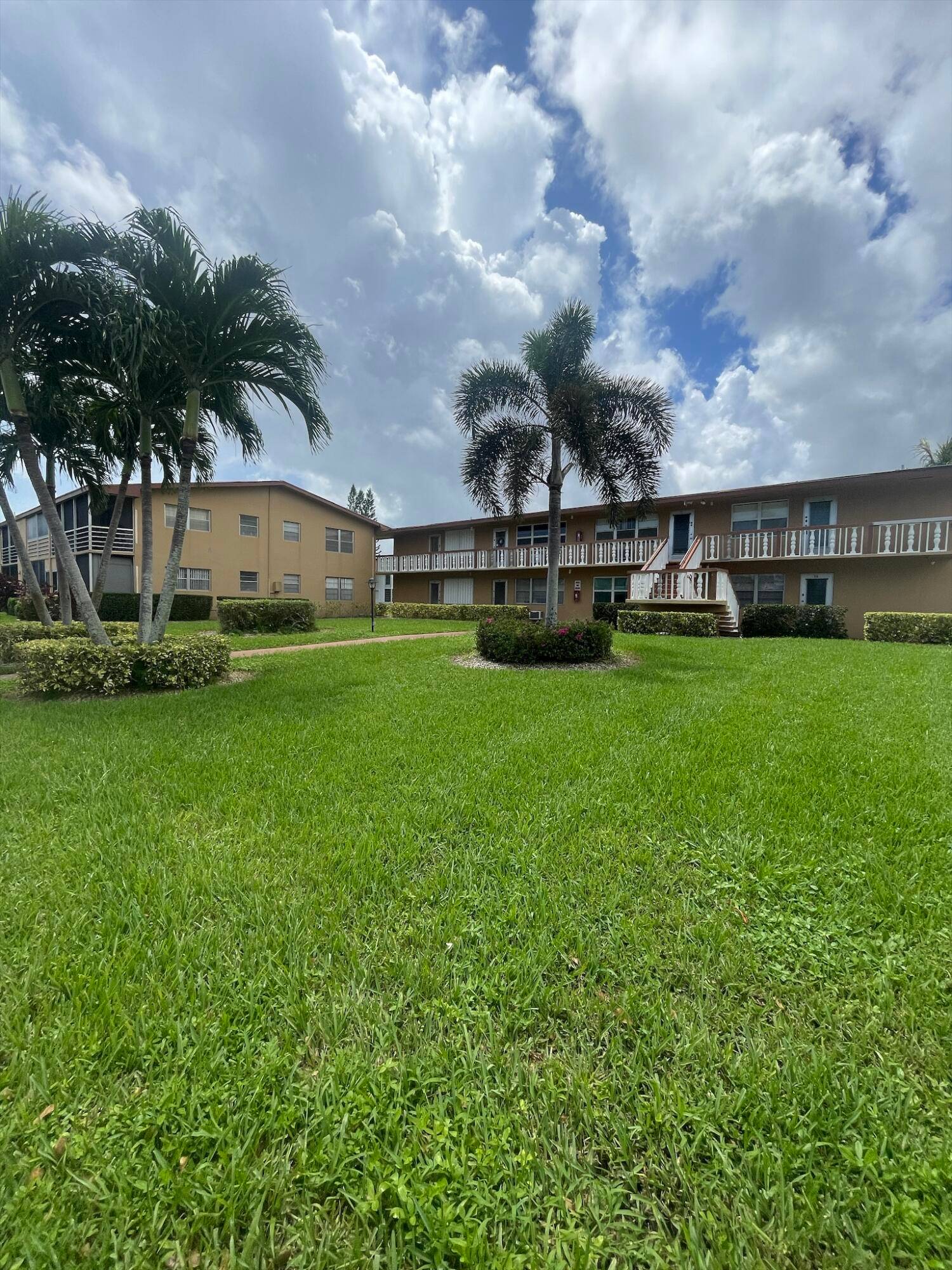 WONDERFUL VERY WELL MAINTAINED AND FULLY FURNISHED, 2ND floor CORNER unit with HURRICANE IMPACT WINDOWS, overlooking a large and beautifully landscaped green space.