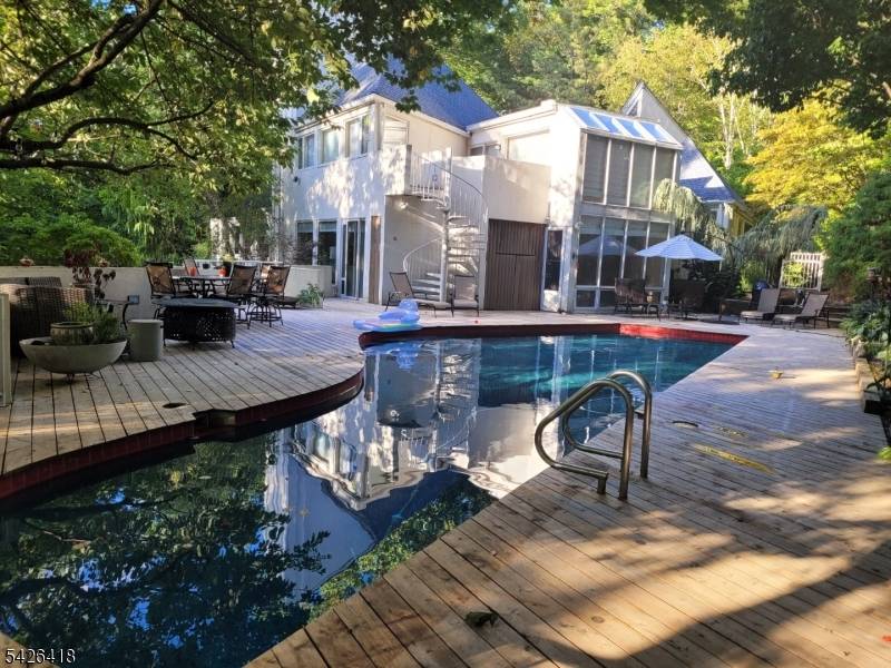 Tucked away on over 3 private, wooded acres just minutes from the vibrant heart of Morristown, this one of a kind custom home offers the perfect blend of luxury, character, ...
