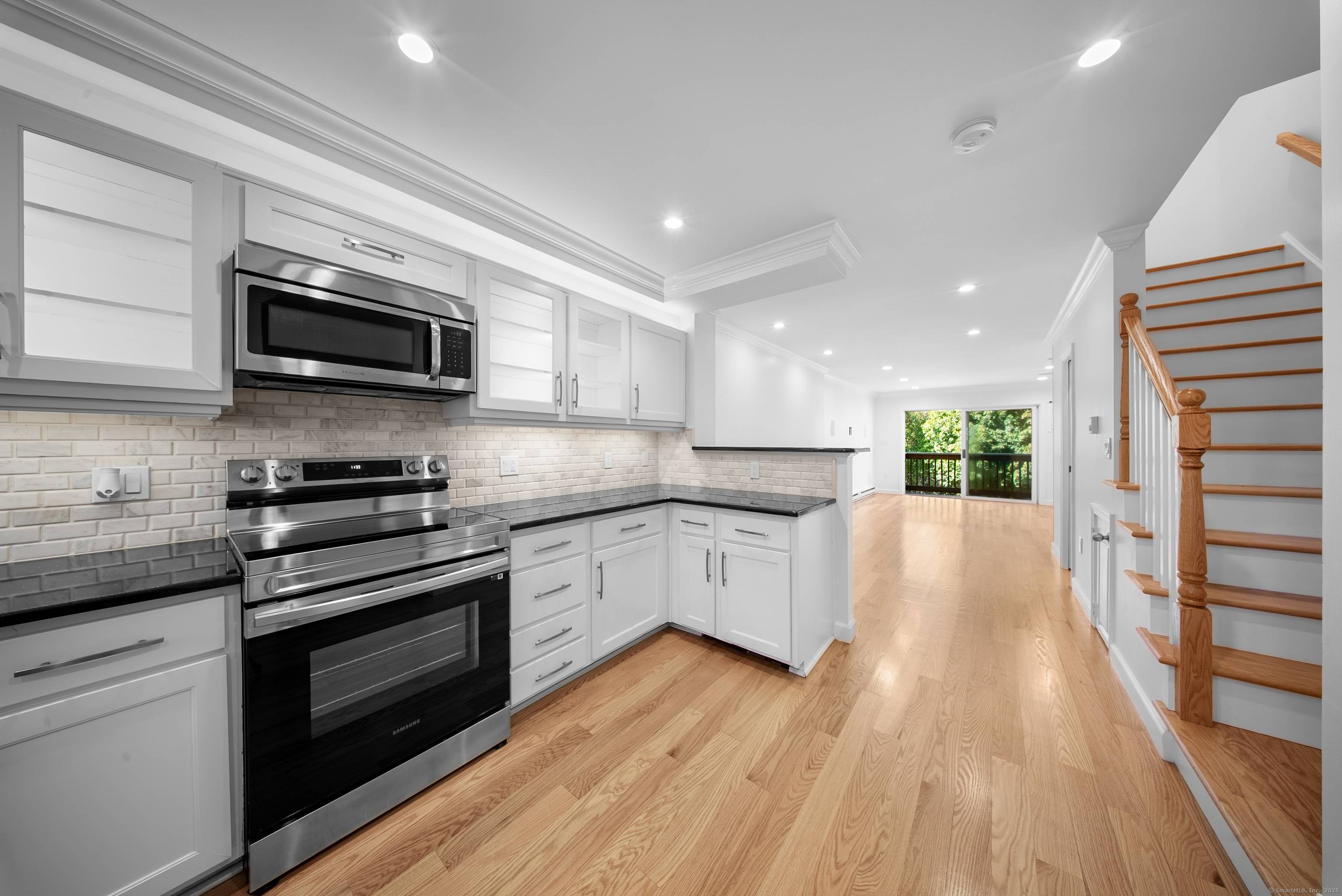 Beautifully updated end unit townhouse featuring hardwood floors throughout, an open concept kitchen and living room, a private balcony and two assigned parking spaces.