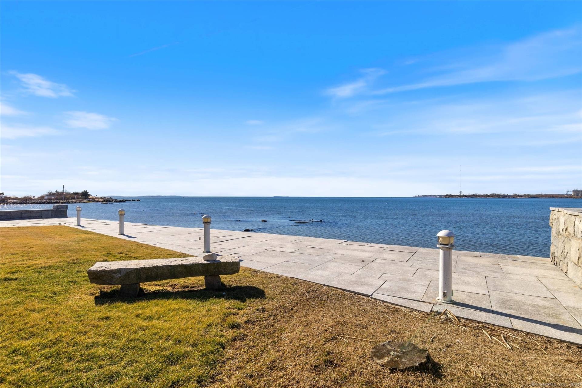 Unwind while lounging in front of Connecticut's most stunning sunsets from this waterfront property with timeless views of L.