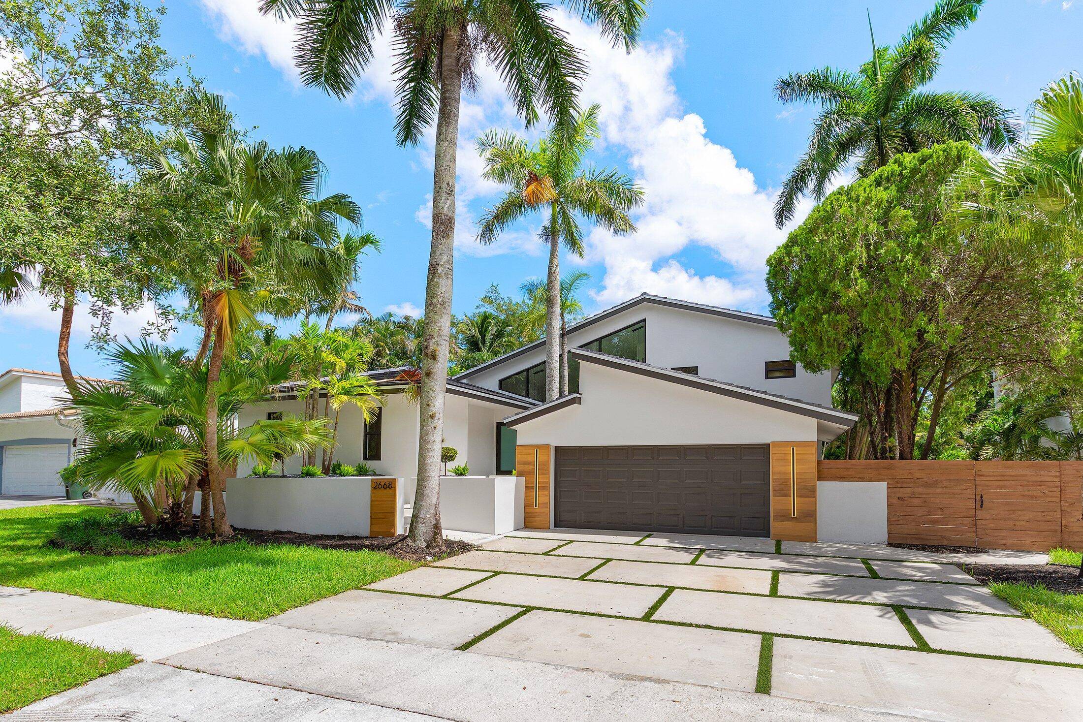 Architectural Elegance Meets Modern PrestigeThis striking residence commands attention with soaring 18 foot wide front windows, flooding the interior with natural light and crafting a showstopping facade.