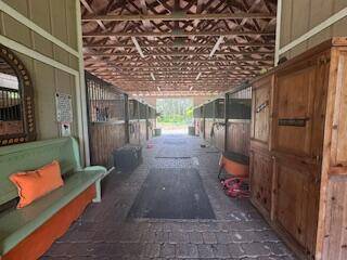 Lovely private farm with 6 stall center isle, tack room, indoor tack up, paddocks and private entrance.