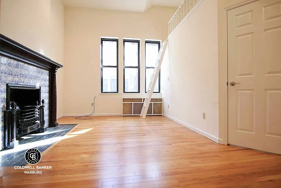 Magnificent 1BR home on parlor floor of lovely historic townhouse, South facing living room with mahogany fireplace w vintage porcelain blue tiles.