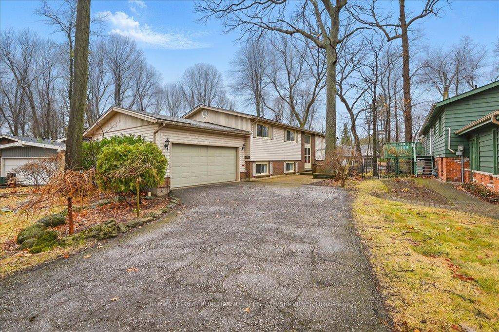 Welcome to this unique Raised Bungalow on a gorgeous private lot with mature trees and gardens in south Burlington.