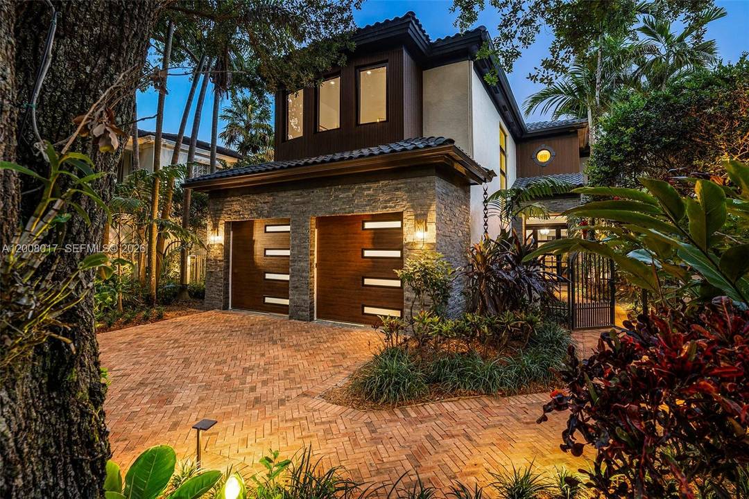 Tucked on a truly enchanting, oak shaded lane just off historic Sunset Drive, this stately 2 story contemporary residence enjoys a premier location at the convergence of Coral Gables, Ponce ...