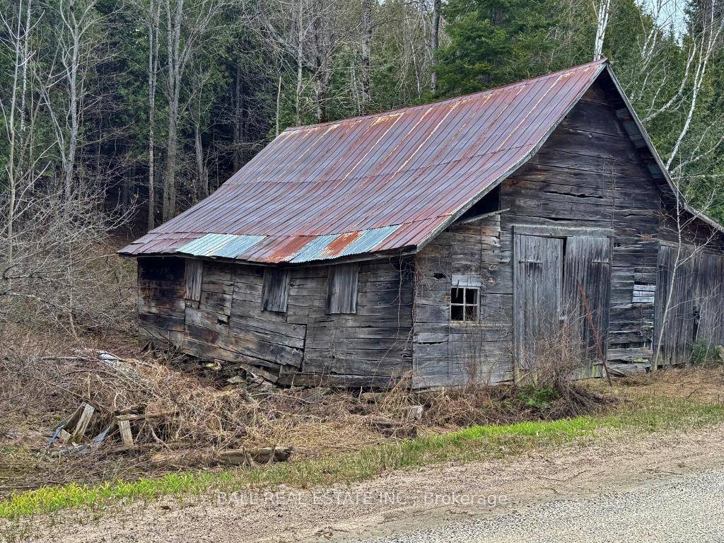 Small lot close to the public beach with an old shed on it.