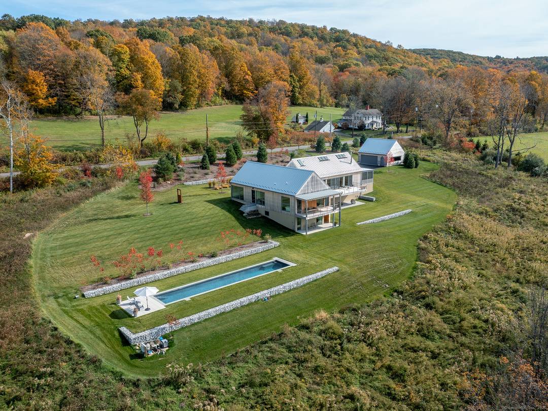 Escape to your sunlight filled, modern architectural retreat on a winding country road in Merryall, just minutes from Lake Waramaug Country Club, Bulls Bridge Golf Club, and the uber chic ...