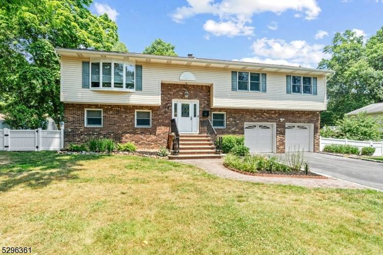 This expansive custom bi level home, located on a tranquil street, features a two car built in garage and a spacious six car driveway.