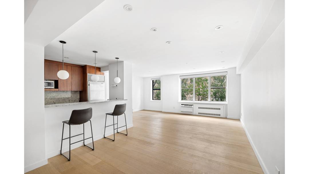 Bright, quiet, and filled with natural light, this beautifully renovated home sits right above the treetops with open southern views of greenery all day long.