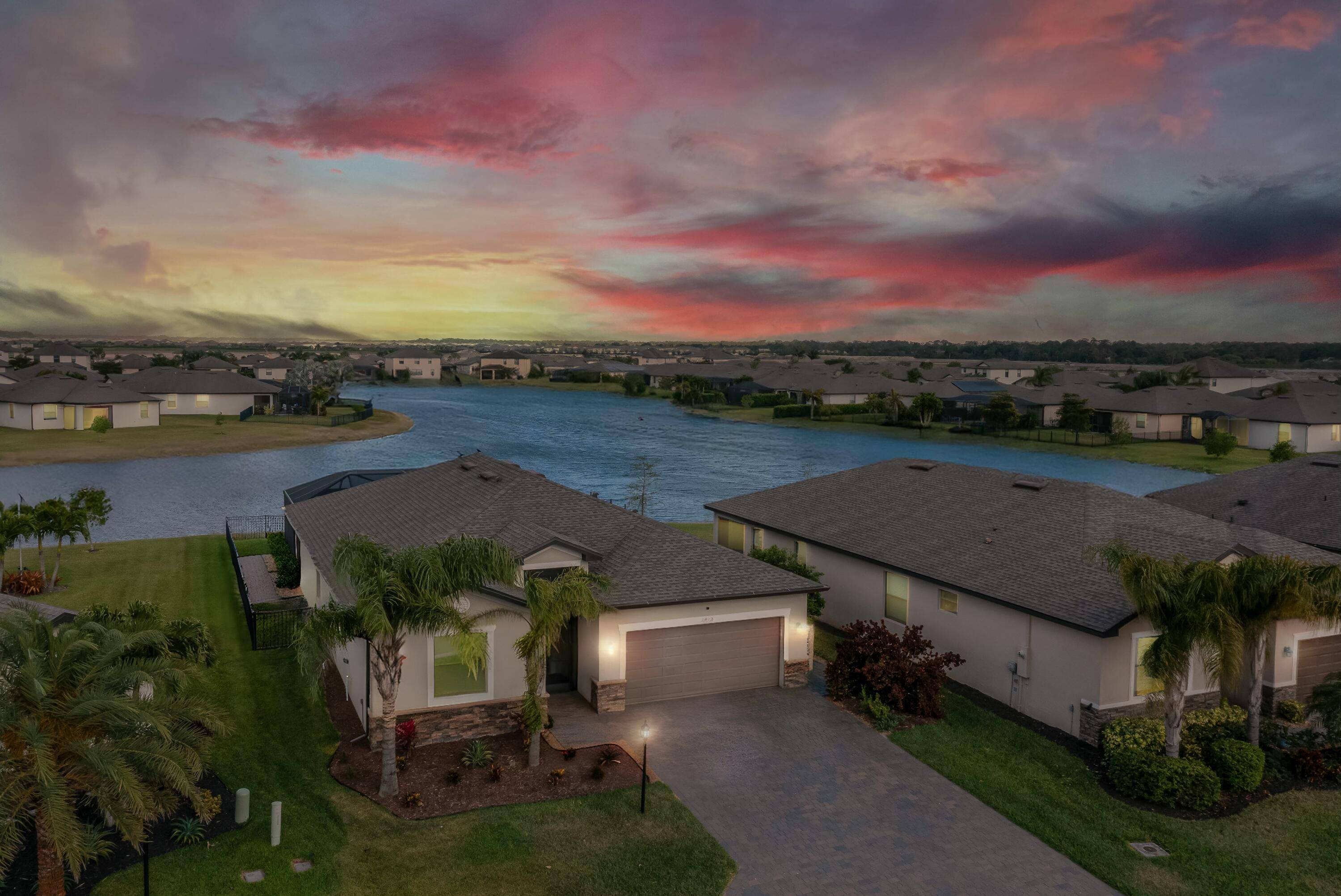 Experience the ultimate in luxury living with breathtaking sunrises and serene moonlit nights in this beautiful lakefront pool home located in the gated Portico community.