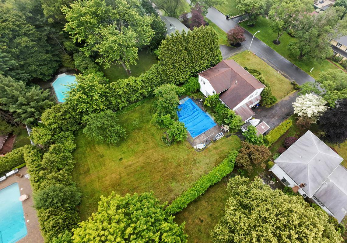Spacious 5 bedroom colonial set on a beautiful, flat property with an inground pool SUPER DESIRABLE LOCATION !