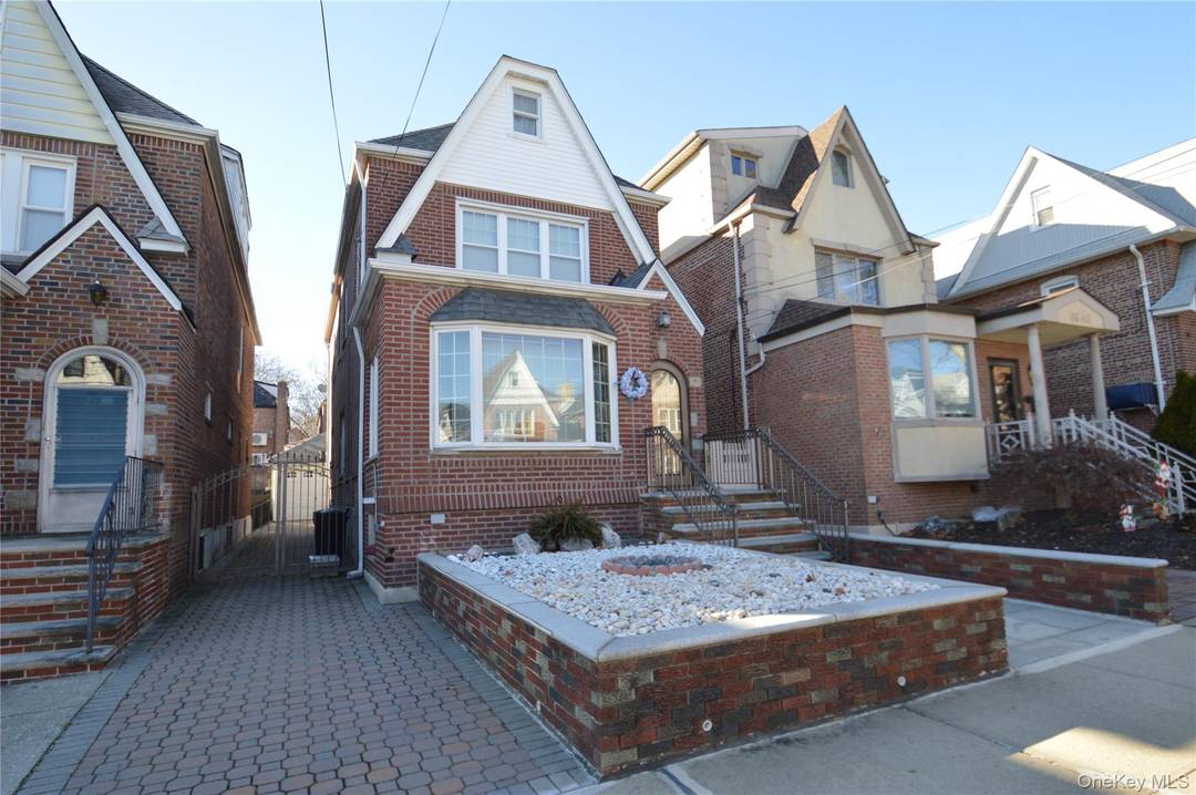 Beautiful 1 family house features Cherrywood flooring in living and dining room with gas fireplace in living room.