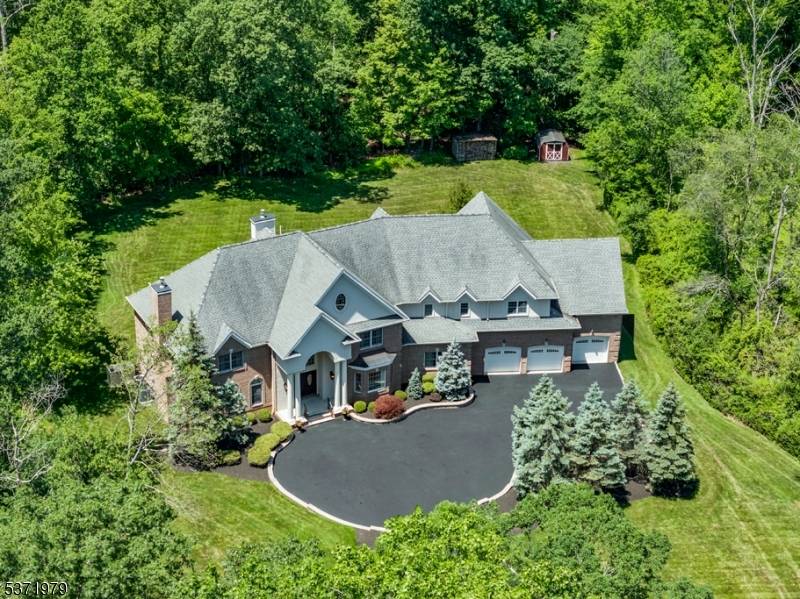 This stunning classic American Traditional is situated on a richly foliated 1.