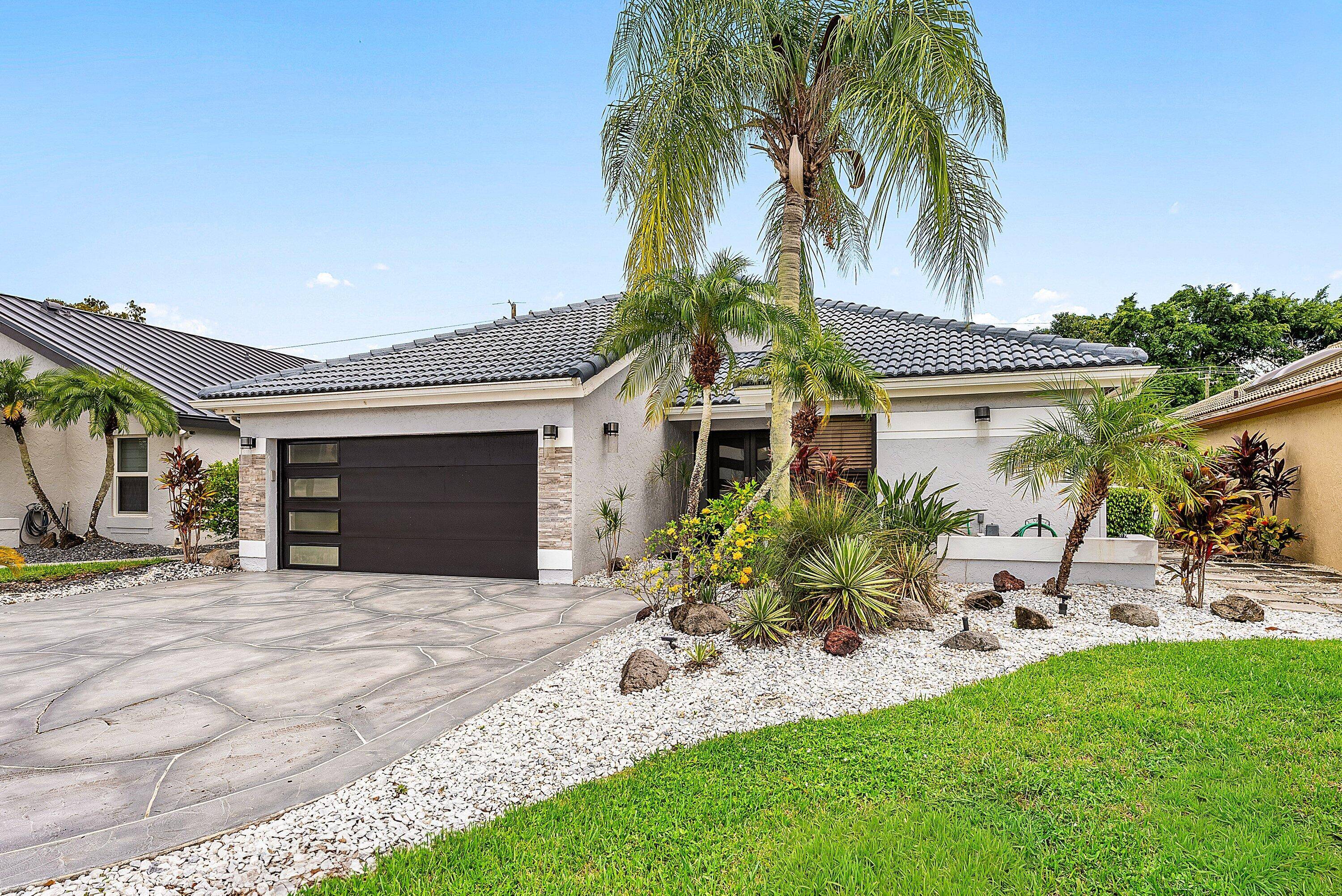Nestled on a quiet cul de sac street in the prestigious Boca Woods Country Club, home features new cabinetry, quartz countertops, subway tile backsplash, premium appliances including Bosch, Verona induction ...