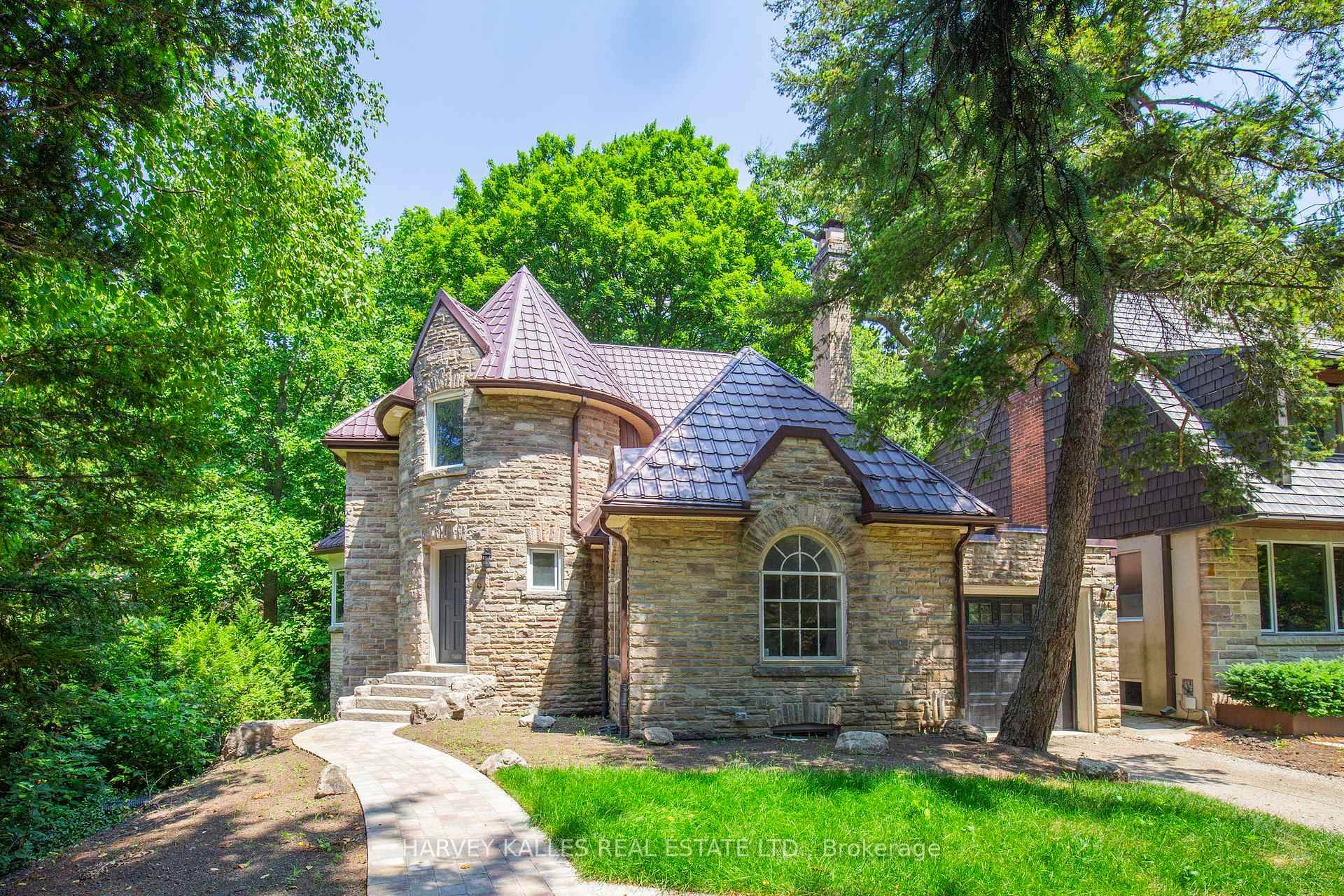 Picturesque castle like stone home, tucked away on a secluded ravine lot.