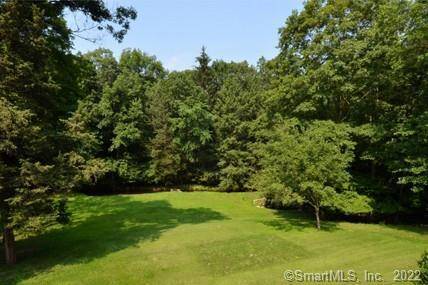 Beautiful 2 acre lot with meadow and gently flowing stream.