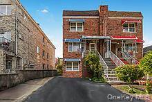 Fantastic opportunity to own a legal two family brick home in the desirable area of Laconia Ave.
